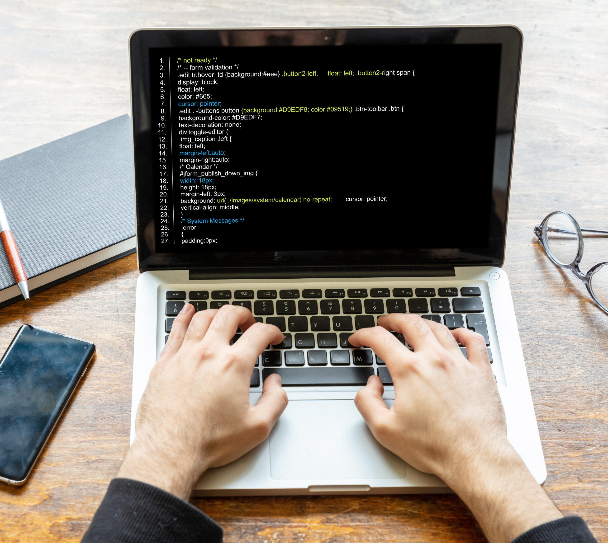Man programming on a computer, office background